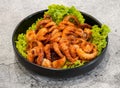 Salted spicy grilled octopus bach tuoc nuong muoi ot chao served in dish isolated on grey background top view of singapore seafood