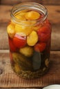 Salted tomatoes cucumbers and squash in a jar