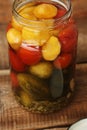 Salted tomatoes cucumbers and squash in a jar