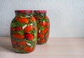 Salted tomatoes in a glass jar. Home preservation.