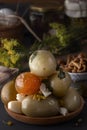 Salted tomatoes in a wooden plate on a background of fermented foods