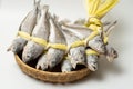 A salted yellow string of dried yellow corvina was placed in a bamboo basket