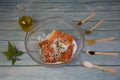 Salting salmon at home, fillet in a transparent bowl olive oil and various spices in wooden spoons Royalty Free Stock Photo