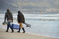 Saltwater fishing Man vs Sea. Full length shot of two young men fishing at the ocean in the early morning. Royalty Free Stock Photo