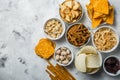 Salty beer snacks in whit bowls Royalty Free Stock Photo