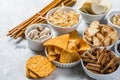 Salty beer snacks in whit bowls Royalty Free Stock Photo