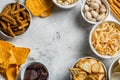 Salty beer snacks in whit bowls Royalty Free Stock Photo