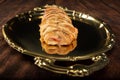 Salty bread stuffed with cheese and ham on a golden tray. Selective focus