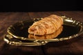 Salty bread stuffed with cheese and ham on a golden tray. Selective focus