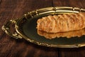 Salty bread stuffed with cheese and ham on a golden tray. Selective focus