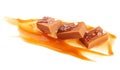 Salty caramel candies in milk caramel sauce with sea salt crystals isolated on white background. Toffee candies Royalty Free Stock Photo