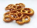 Salty crispy cracker mini pretzels on white background