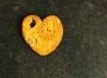 Salty croutons with bread on a dark background, in the shape of a heart, in a close-up