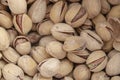 Salty delicious open pistachios in a bowl. brown natural background from natural nuts Royalty Free Stock Photo