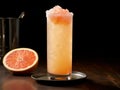 a Salty Dog cocktail served in a tall, thin glass with a salt crust rim