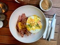 Salty Pancakes with Hollandaise Sauce, Melted Cheddar Cheese, Eggs and Crispy Bacon for Breakfast. Salted Food Royalty Free Stock Photo