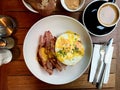 Salty Pancakes with Hollandaise Sauce, Melted Cheddar Cheese, Eggs and Crispy Bacon for Breakfast. Salted Food Royalty Free Stock Photo