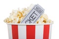 Salty popcorn in box and movie ticket, isolated on white. Royalty Free Stock Photo