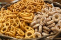 Salty pretzels close-up in wicker basket, top view.