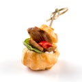 Salty profiterole appetizer with fish on white