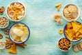 Salty snacks, overhead flat lay background with copy space. Party food frame Royalty Free Stock Photo