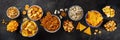 Salty snacks, party mix, overhead flat lay panorama. An assortment of appetizers