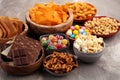 Salty snacks. Pretzels, chips, crackers in wooden bowls.