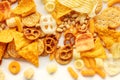 Salty snacks texture on white. Party food assorted mix. Potato chips etc Royalty Free Stock Photo