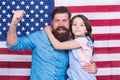 Saluting the great banner. Patriotic family celebrating flag day with banner decor. Father and little daughter on Royalty Free Stock Photo