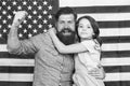 Saluting the great banner. Patriotic family celebrating flag day with banner decor. Father and little daughter on Royalty Free Stock Photo