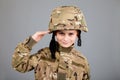 Saluting soldier. Young boy dressed like a soldier Royalty Free Stock Photo