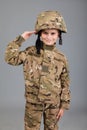 Saluting soldier. Young boy dressed like a soldier