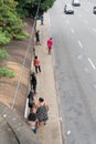 Salvador, Bahia, Brazil - August 11, 2023: Passengers standing waiting for transport at a bus stop on Avenida Tancredo Neves