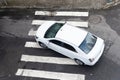 Salvador, Bahia, Brazil - August 11, 2023: A white colored car passing by the crosswalk on Avenida Tancredo Neves