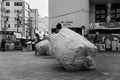 Beer can pickers are seen carrying huge bags after Carnival night