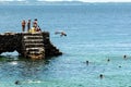 People and tourists are on top of the stone pier of Porto da Barra