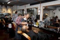 Barber working in barbershop