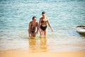 Salvador, Bahia, Brazil - June 04, 2022: Mother and daughter, in bikinis, are coming out of the water at Porto da Barra beach in