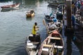 People removing goods from the boats docked on the deck of the SÃÂ£o Joaquim fair, in Salvador, on a sunny day