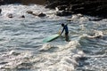 Surfer entering the sea from Farol da Barra beach. Salvador, Bahia, Brazil Royalty Free Stock Photo