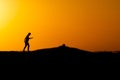 A person, in silhouette, is seen on the Porto da Barra pier against the sunset in the city of Salvador, Bahia Royalty Free Stock Photo