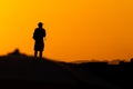 A person, in silhouette, is seen on the Porto da Barra pier against the sunset in the city of Salvador, Bahia Royalty Free Stock Photo