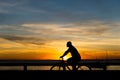 Silhouette of cyclist at sunset walking along the edge of Ribeira beach Royalty Free Stock Photo