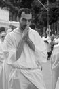 A young priest prays during the Corpus Christ procession