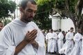 A young priest prays during the Corpus Christ procession