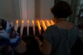 People pray in front of candles inside the Campo Santo cemetery church on the Day of the Dead holiday in the city of Salvador,