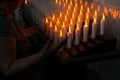 People pray in front of candles inside the Campo Santo cemetery church on the Day of the Dead holiday in the city of Salvador,