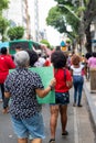 Demonstrators walk with posters, banners and flags during the Crespo Empowerment March in Salvador, Bahia