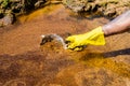 Volunteer hands cleaning oil on Rio Vermelho beach after spillage from a ship off the Brazilian coast