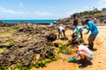 Volunteers remove black oil from the Rio Vermelho beach spilled by a ship in the Brazilian sea